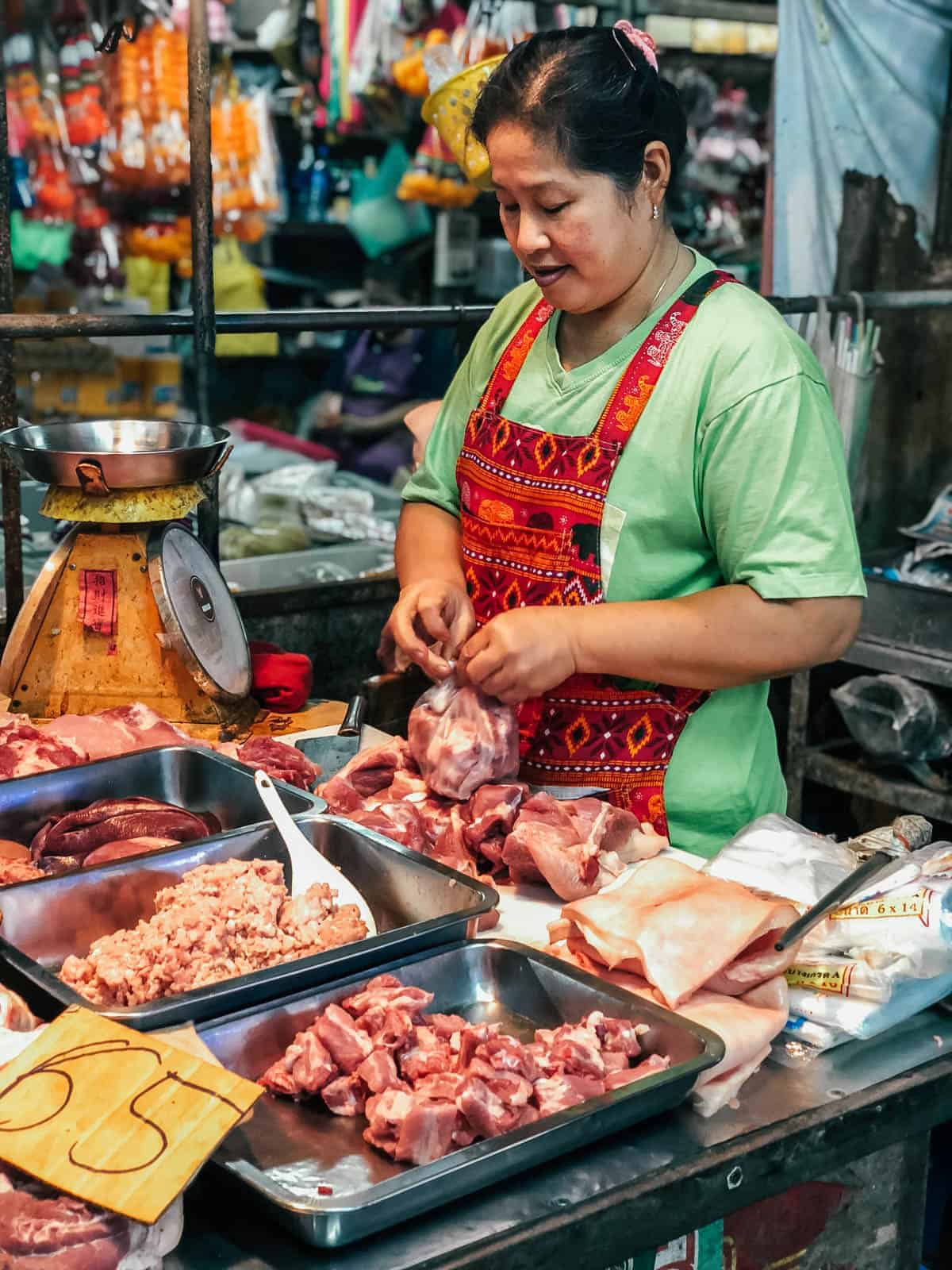 Woman preparing food at meeklong train market in bangkok