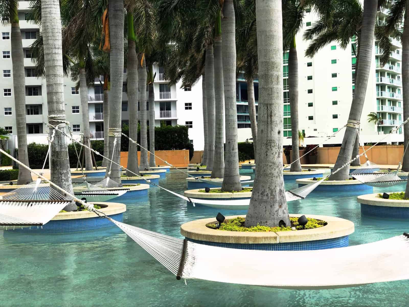 Four Seasons Miami pool with hammocks hanging. 