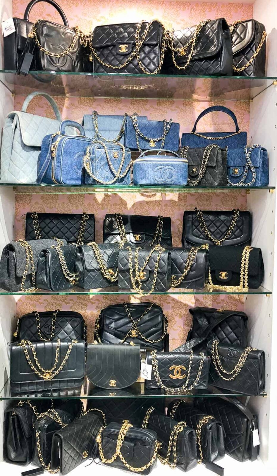 Bookshelf filled with vintage Chanel handbags at Vintage Qoo luxury resale store in Tokyo