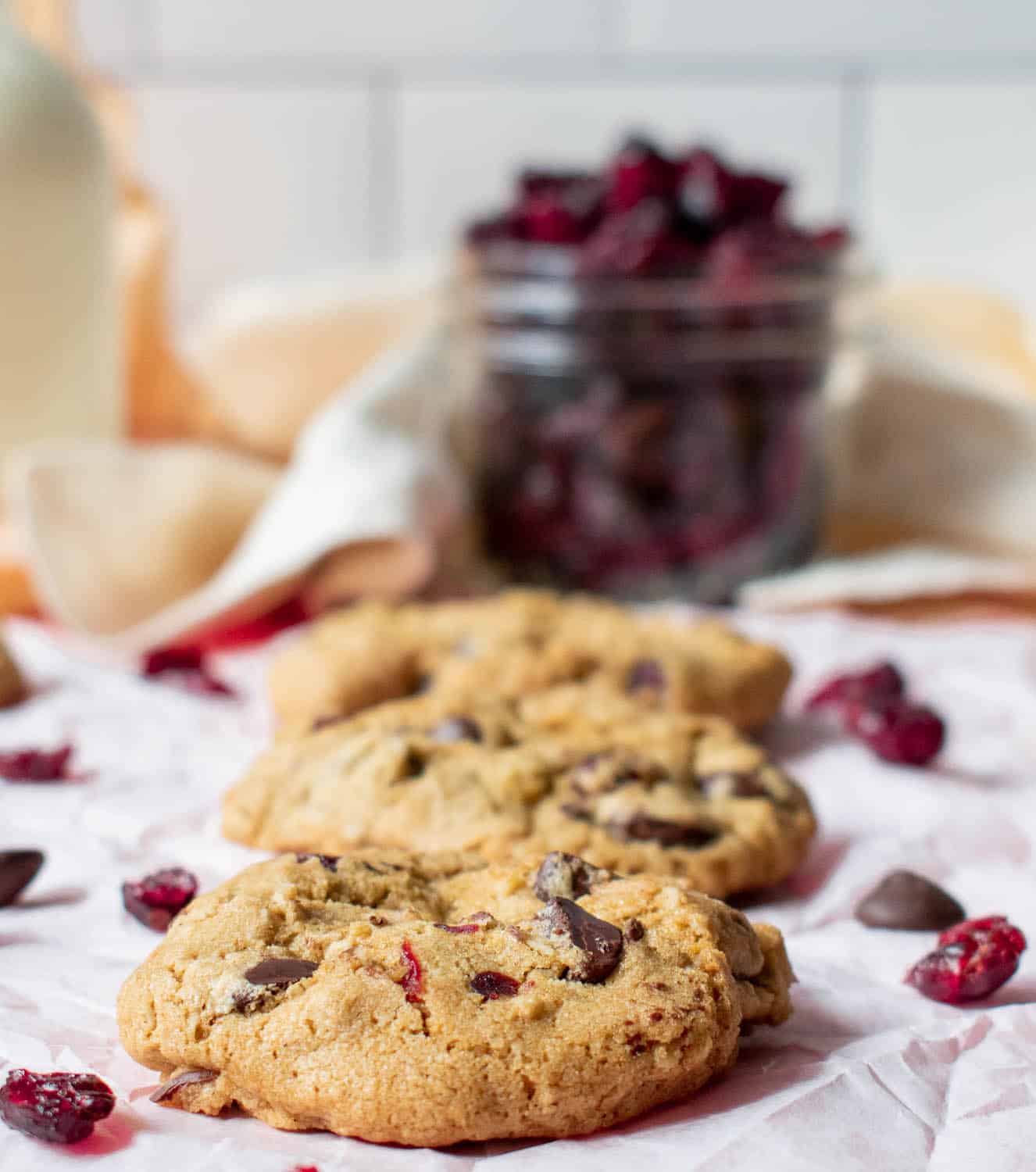 Gluten-free cookies on a table with dried cranberries all around