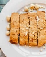 Plate of gluten free biscotti with white chocolate and macadamia nuts