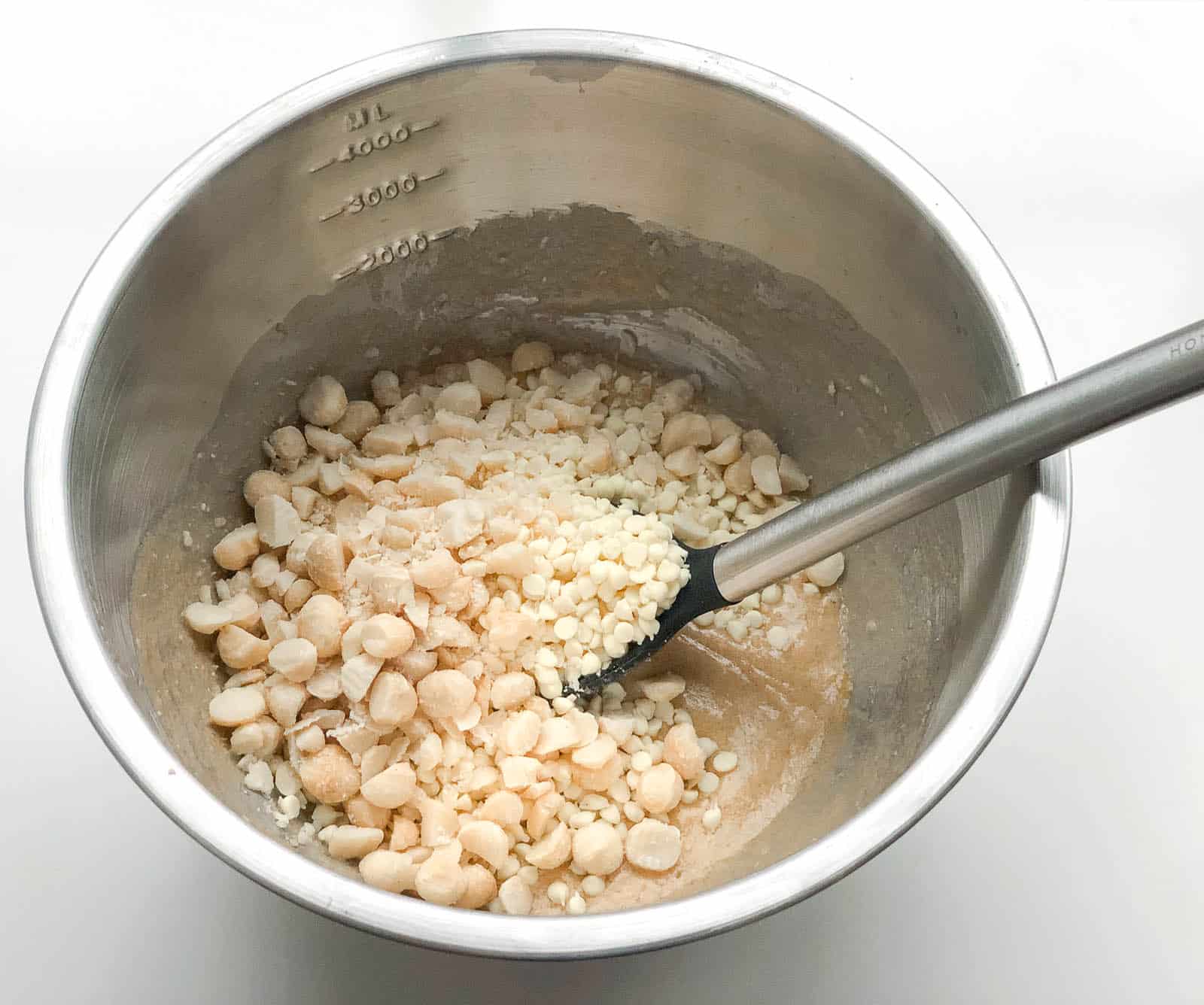 Macadamia nuts and chocolate chips in a bowl to make biscotti cookies