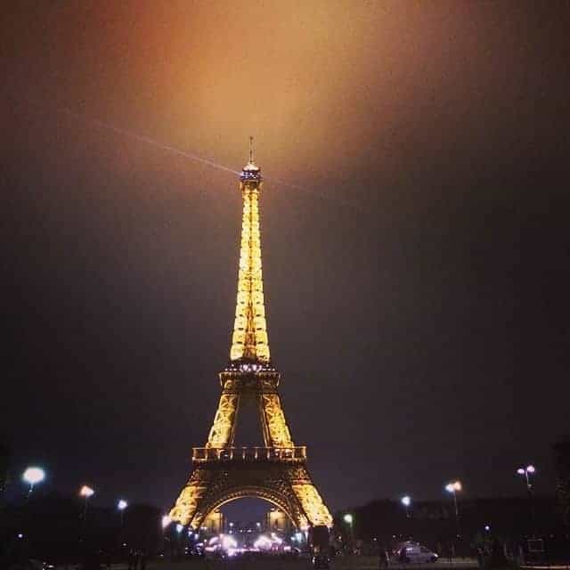 Eiffel tower lit up at night in Paris