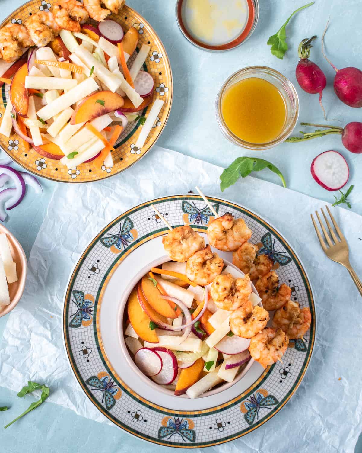 Plates of jicama peach salad and air-fryer shrimp with lime and ginger. 