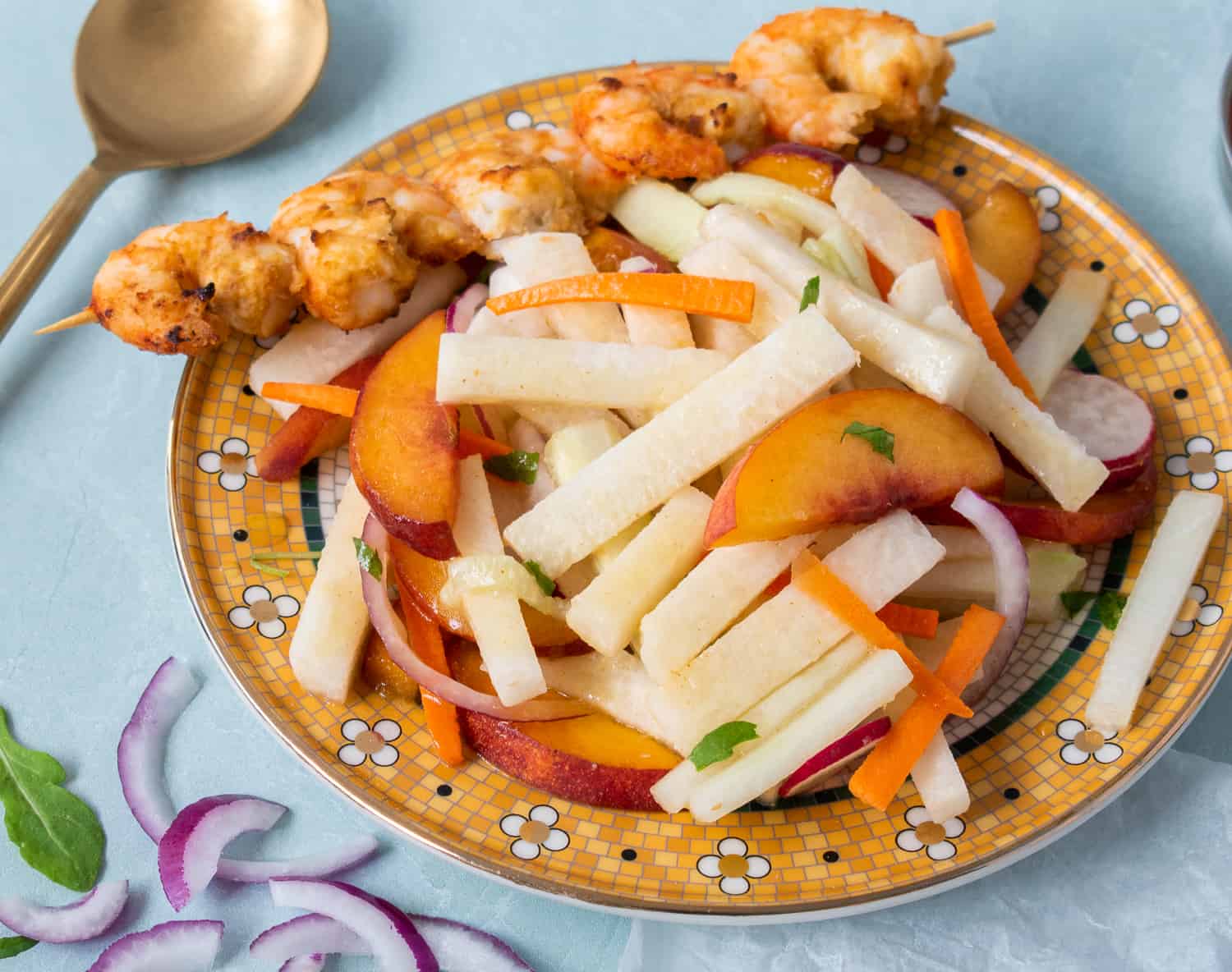 Close up of jicama peach salad and shrimp with lime and ginger. 