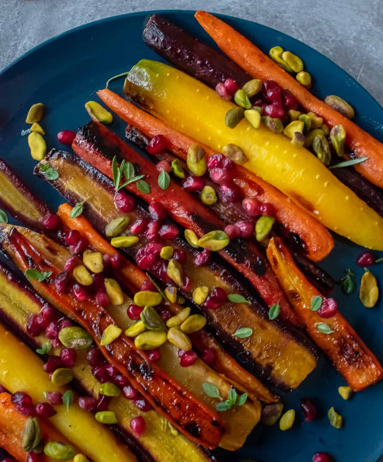 Try this easy, healthy and delicious side dish recipe of roasted rainbow heirloom carrots with orange-honey glaze, pomegranate seeds and pistachios.