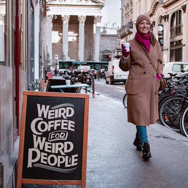 A woman outside a coffee shop in Paris