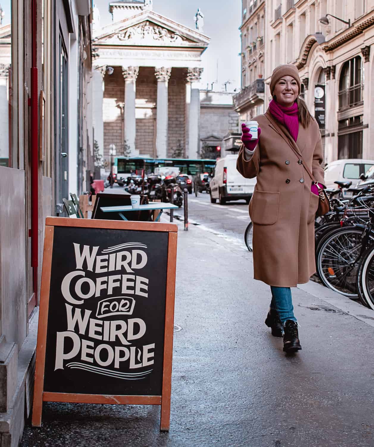 A woman outside a coffee shop in Paris